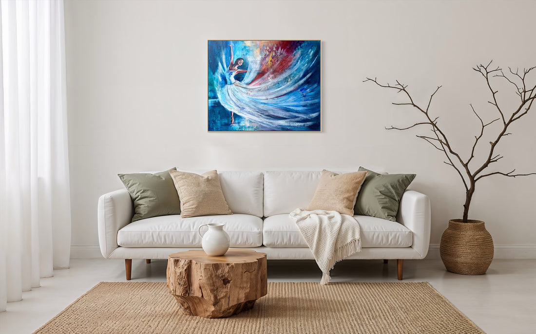 Beautiful colourful dancer with blues and reds and whites, framed in wood. In front of a modern home with neutral coloured couch and house.