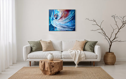 Beautiful colourful dancer with blues and reds and whites, framed in wood. In front of a modern home with neutral coloured couch and house.