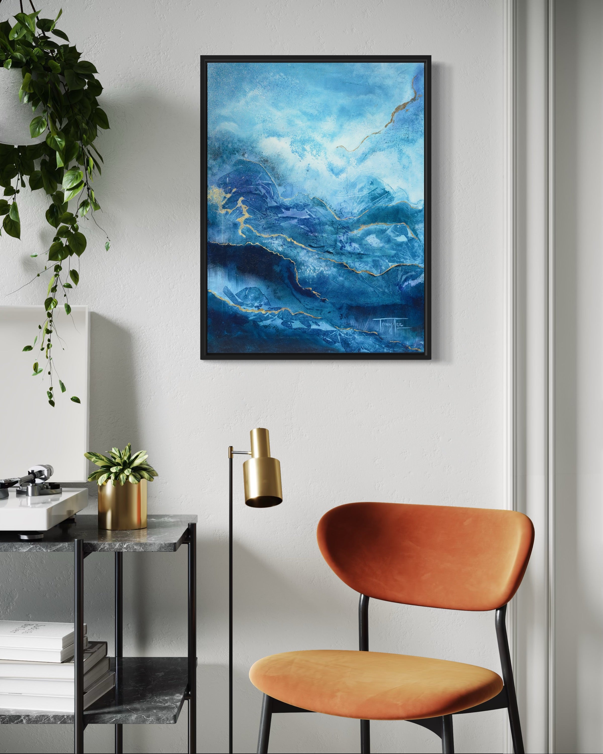 Modern interior with a blue abstract painting, orange chair, and gold lamp.