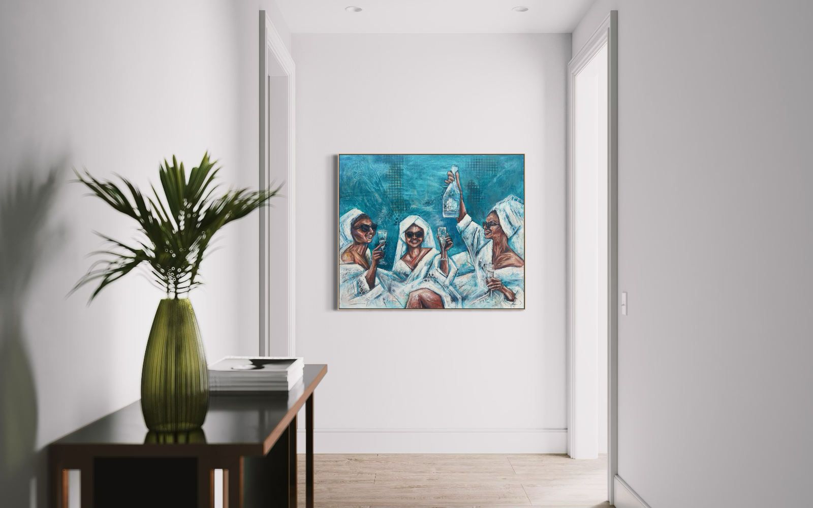 A framed canvas painting depicting three women in white robes against a blue background, displayed in a modern hallway setting with a side table and green plant in the foreground.