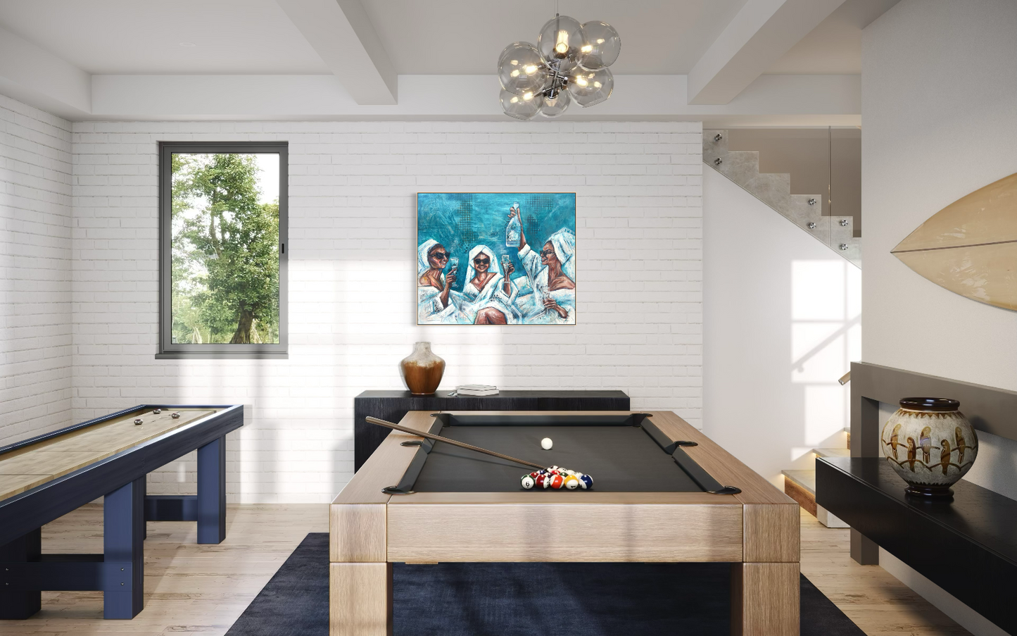 A framed painting depicting three figures in white robes against a blue background, displayed on a black console wall in a modern, sunlit room with a pool table, a window, and a staircase.