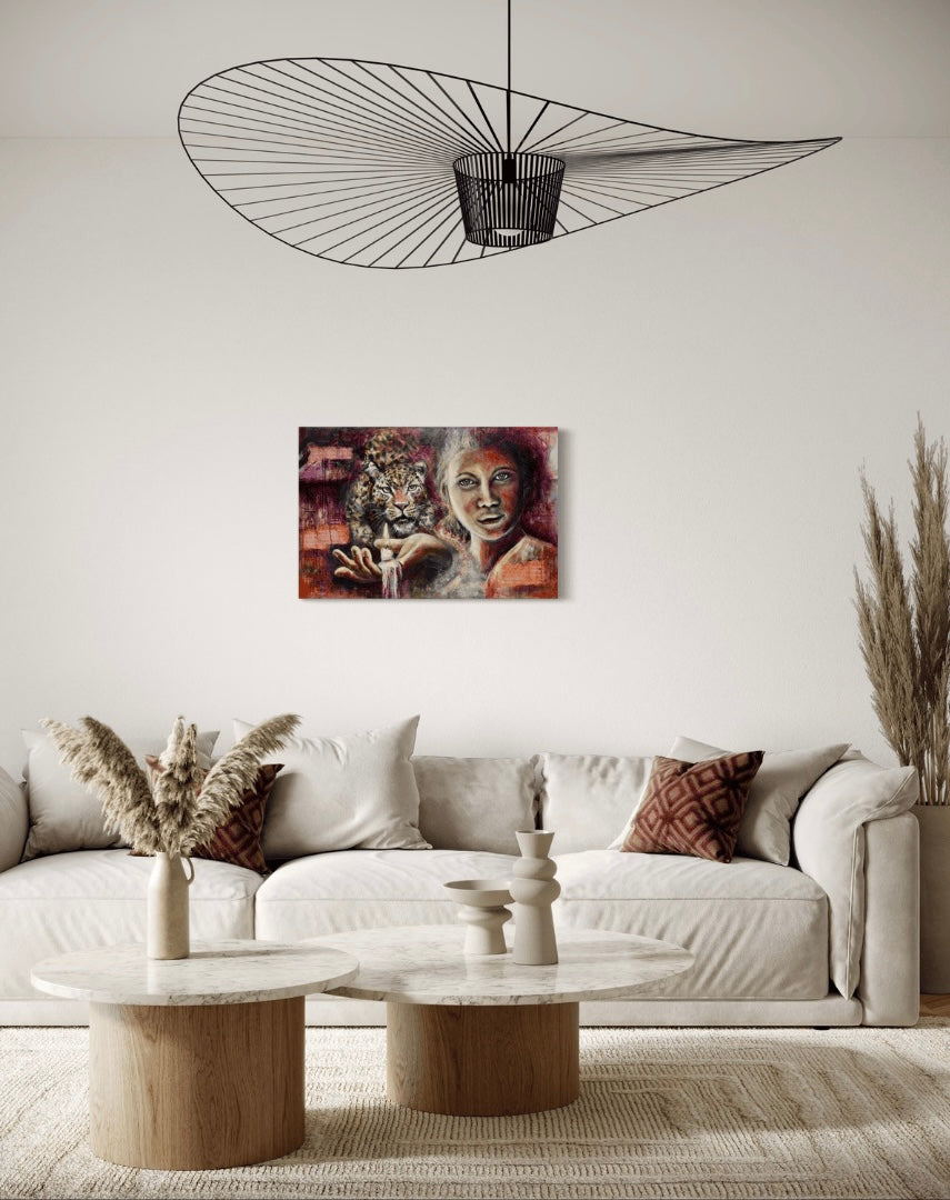 A painting titled Shining Light hangs above a modern neutral coloured couch with modern light fitting.