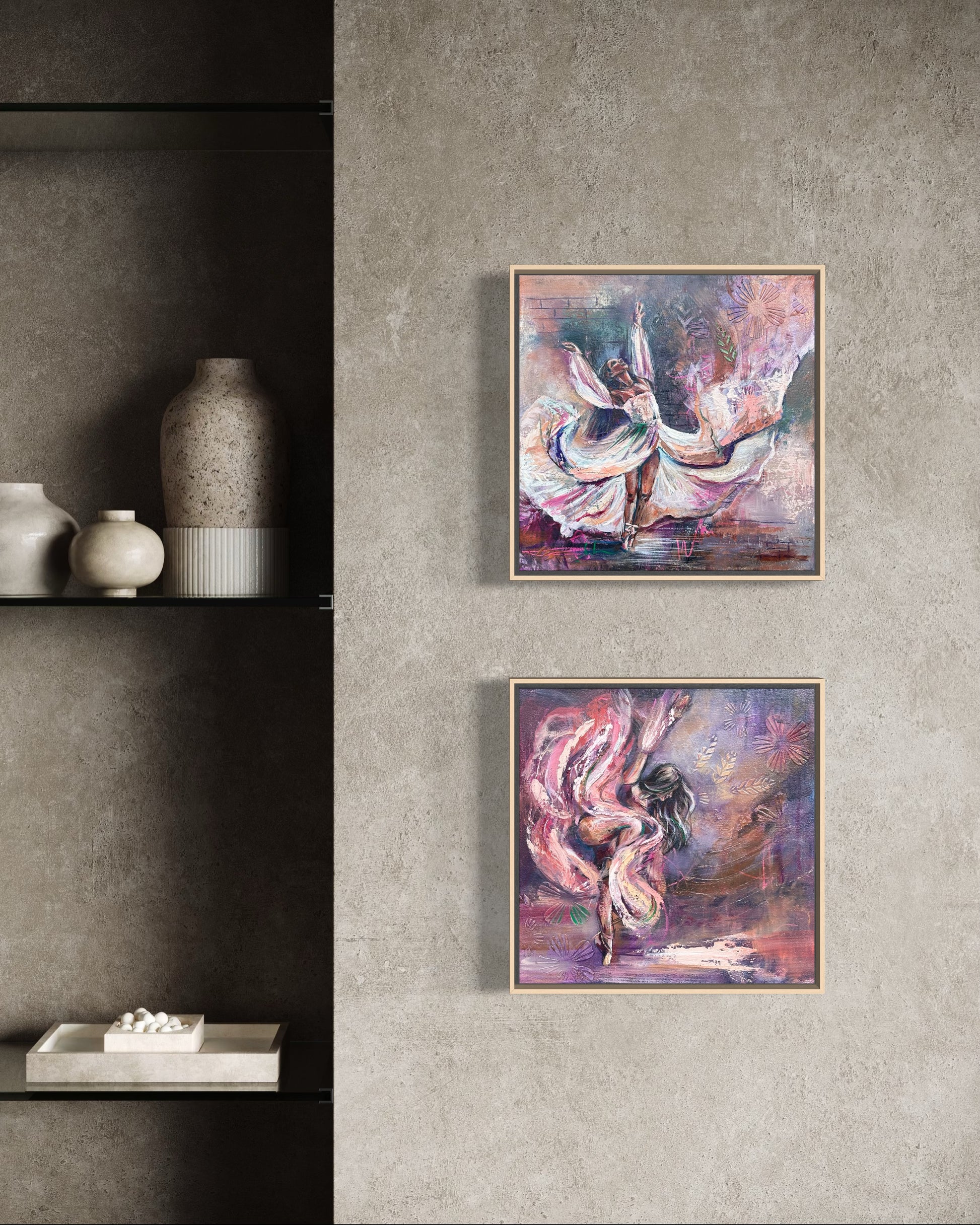 Two framed artworks of dancers on a grey wall with decorative vases below. The dancers have flowing dresses and have purple and pink tones mixed with neutral colours and whites. The Paintings both capture a lot of movement and emotion.