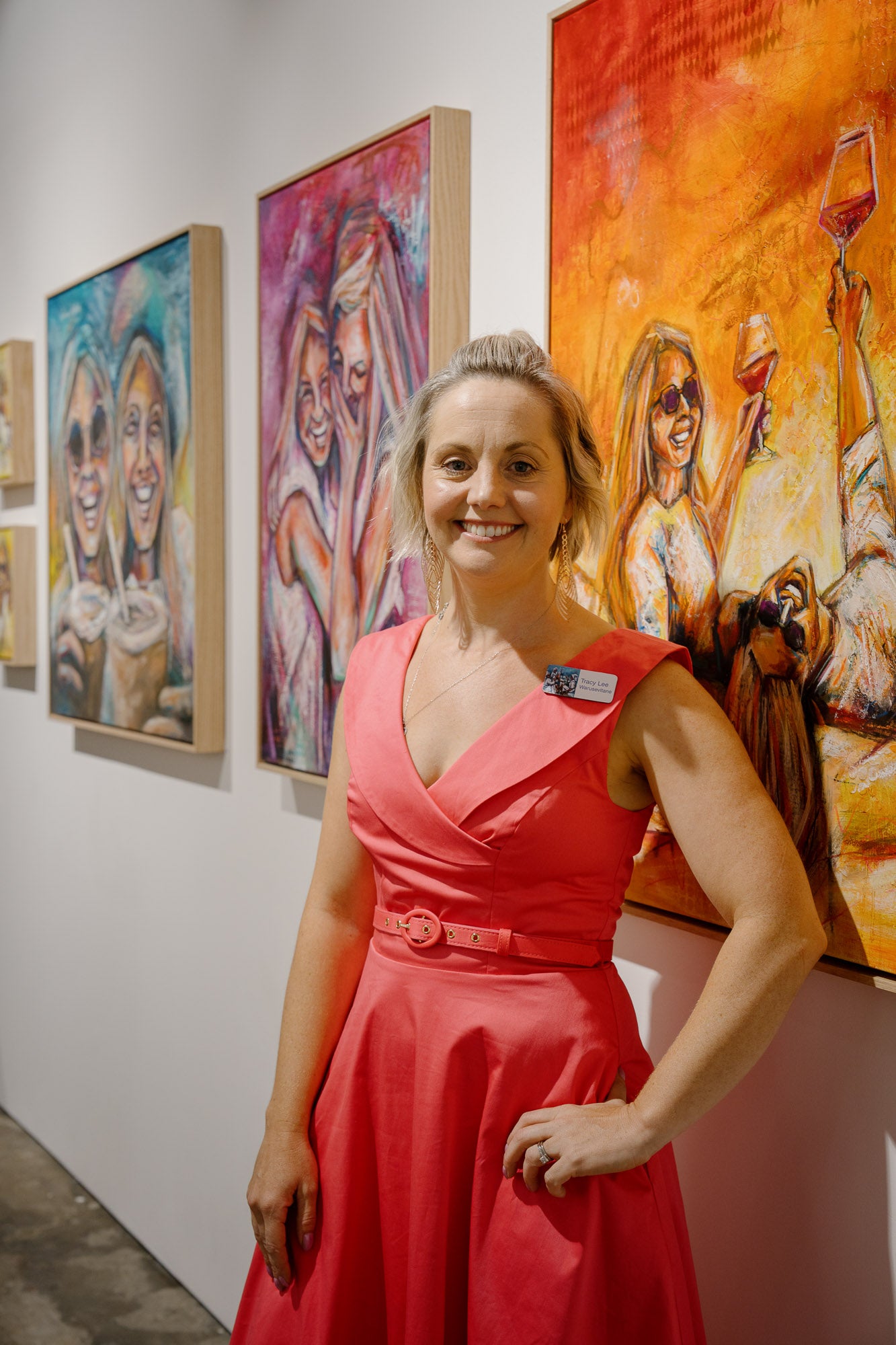 Image Credit to SOL Gallery, Tracy Lee Warusevitane standing in front of her "Girls just want to have fun" series exhibiting at SOL Gallery Fitzroy Australia